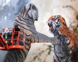 Sonny painting tiger mural painted during Art Basel Miami, for aWalls Mural Project in Wynwood